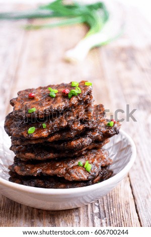 Fritters of liver.  Pancakes from the liver.  Food photo. Wooden background.