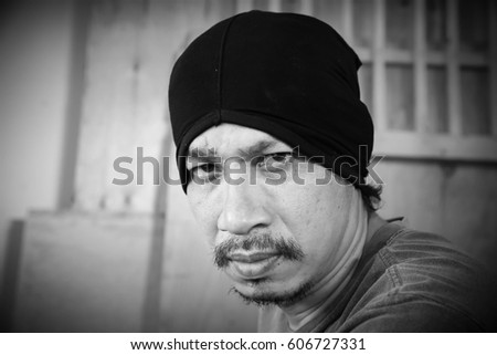 Portrait of serious man sitting  in room,Man face expressions,Danger,Black and white