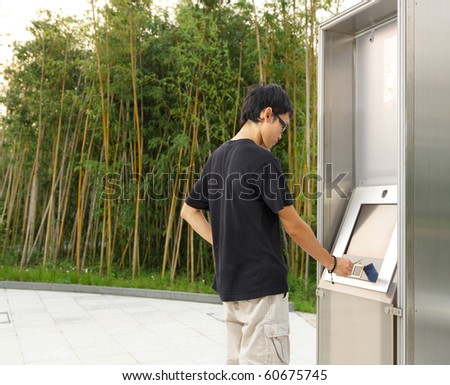 man using touch screen outdoor