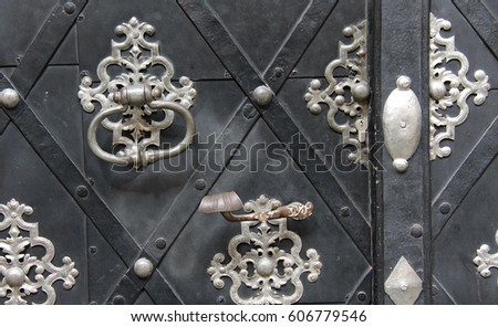Black iron door with gray openwork patterns