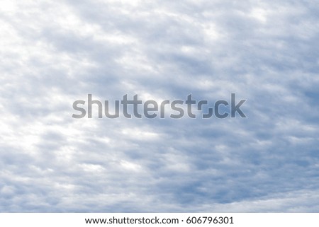 Cloudy blue sky with the sun illuminating the clouds