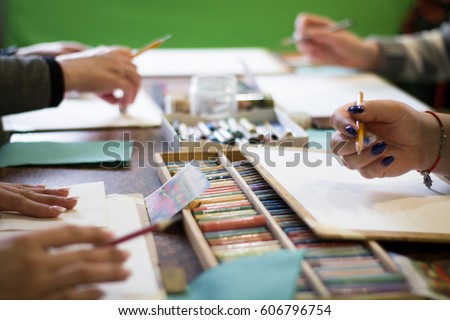 Drawing lesson for children and adults. Pastel pencils. Beautiful pastel picture. many people. Box with pencils on the table. Many materials.
