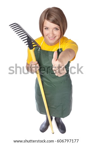 funny garden worker. top view of happy woman gardener or florist with rake making thumb up gesture isolated on white background. wide angle full body portrait from above. advertisement gesture