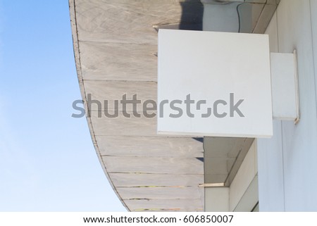 horizontal side view of empty white square signage on the exterior of a building