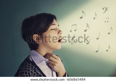 teen singer boy sing close up portrait on blue background Royalty-Free Stock Photo #606865484