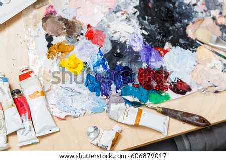 Artist table with paints, palette