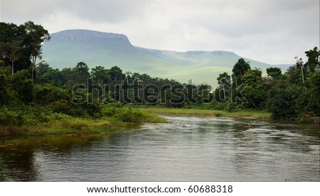 Small river in jungle. Under the cloudy sky through hills and mountains the small river proceeds on jungle. Royalty-Free Stock Photo #60688318