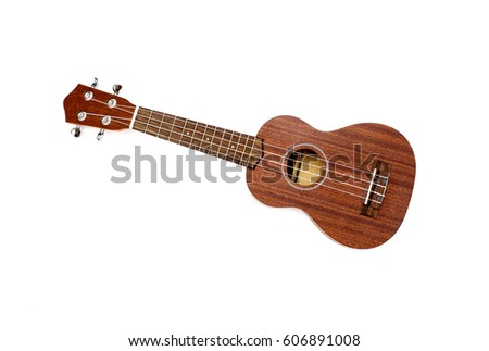 The brown ukulele on the white background Royalty-Free Stock Photo #606891008