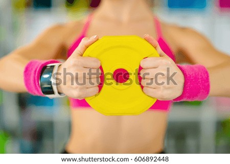 Fitness blonde woman standing with dumbbells back sport health