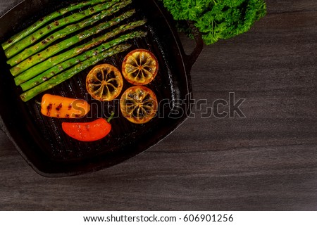 grilled organic asparagus with lemon pepper in a grill frying pan