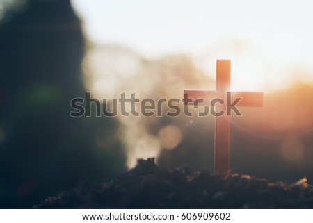 cross on blurry sunset background. Christian, Christianity, Religion copyspace background. Royalty-Free Stock Photo #606909602