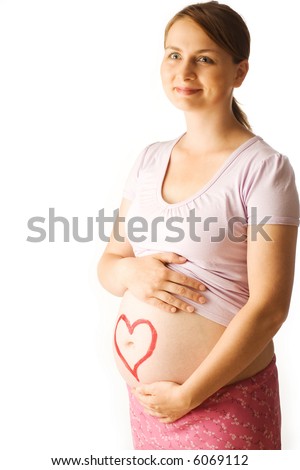 A picture of an expectant mother, smiling as she gently touches her belly.