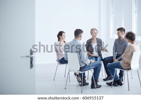 People participating in group therapy for social skills training Royalty-Free Stock Photo #606915137
