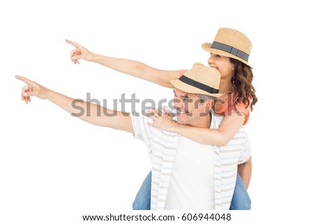 Handsome man piggy backing his wife against white background