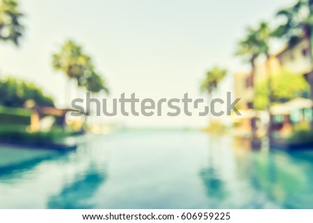 Blur summer background for resort hotel relaxation swimming pool party with blue cool sky and tropical palm tree