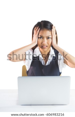 Nervous businesswoman using a laptop on white background