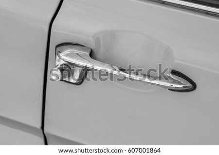 Retro car door handle. Monochrome style photo.