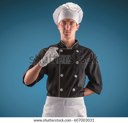 Chef with bussiness card on a blue background. Modern chef concept.