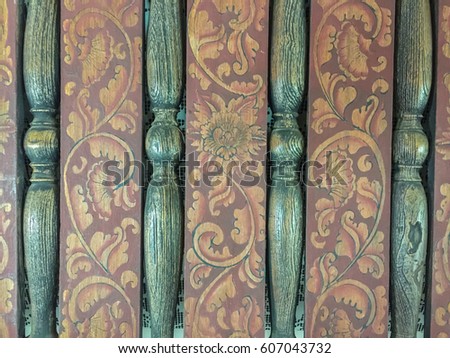 Abstract texture of decorative terrace consists of four greenish woods in vertical line and flowers picture painted on cloth