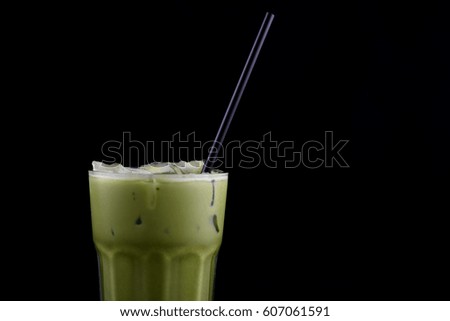 Iced macha green tea isolated from black background