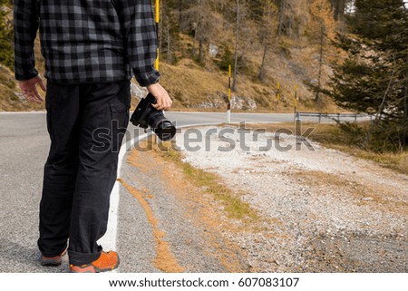 Photographer standing beside the road for looking his angle to take photo in Bolzano ,Italy.