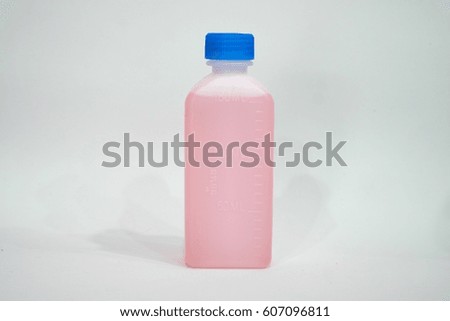 bottle of pink liquid on the white background