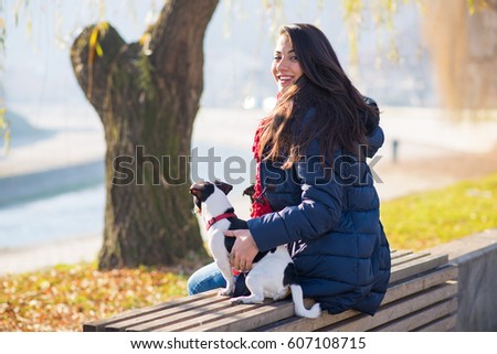 Beautiful and happy woman enjoying in park with her with dogs.Colored photo