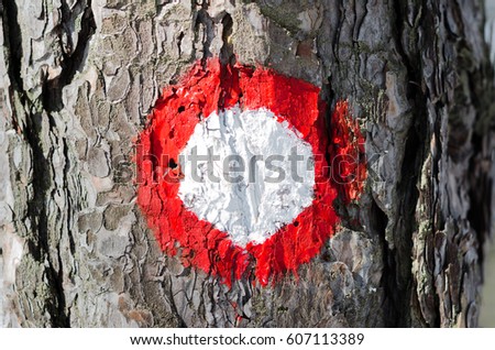 Round red sign on a tree, a signpost, a ban on cutting,concept of emoticon
