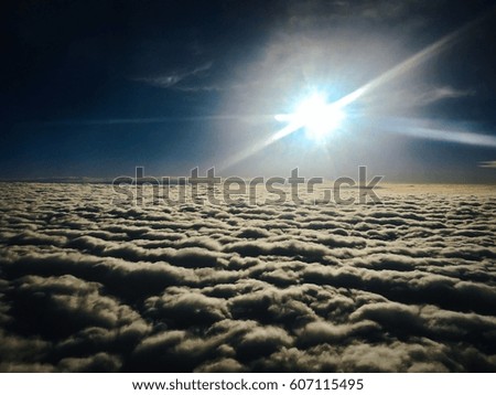 Morning Sun above the clouds. Sunrise from an airplane window in Europe