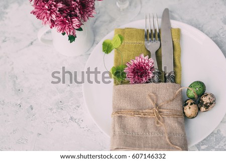 Fork with knife, blank plates, and napkin. Easter table settings. Top view.