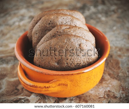 Homemade chocolate cookies for snack. Chocolate chip cookies shot in ceramic jar, closeup.