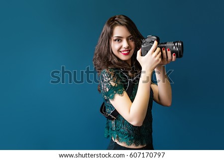 Woman takes images holding photographic camera