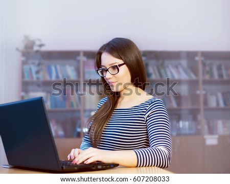 intelligent, attractive girl student on the desk at the institute