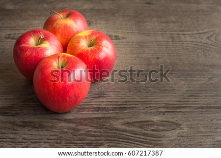 Juicy apples on a brown board with place for a text
