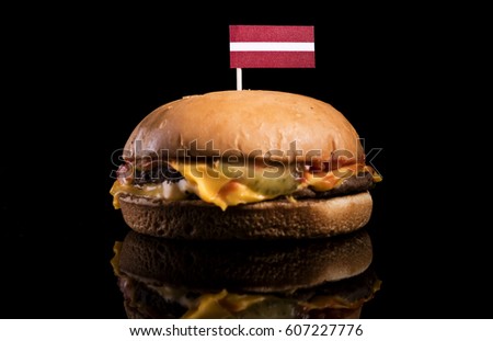 Latvian flag on top of hamburger isolated on black background