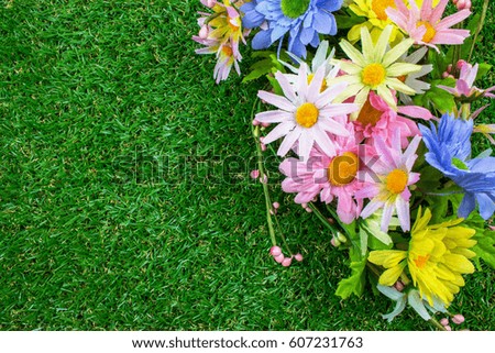 Spring Plastic Flowers on Green Grass.