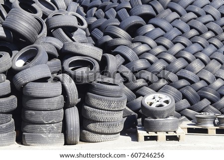 A pile of folded used car tires