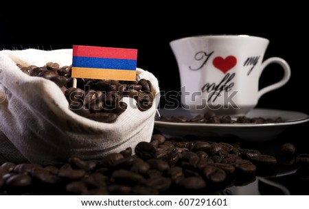 Armenian flag in a bag with coffee beans isolated on black background