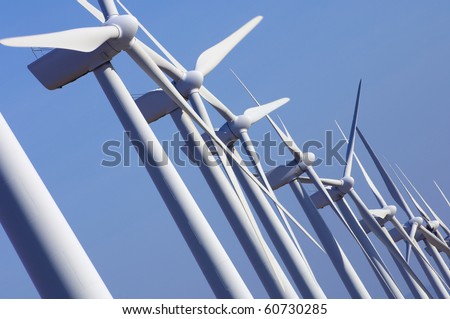 group aligned modern windmills for renewable electric energy production Royalty-Free Stock Photo #60730285