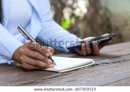 female freelancer connecting to wireless on tablet, thoughtful businessman work on tablet while sitting at wooden table in modern coffee shop interior,news update journalism media concepts
