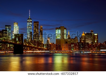 New York City's Brooklyn Bridge and Manhattan skyline illuminated at night