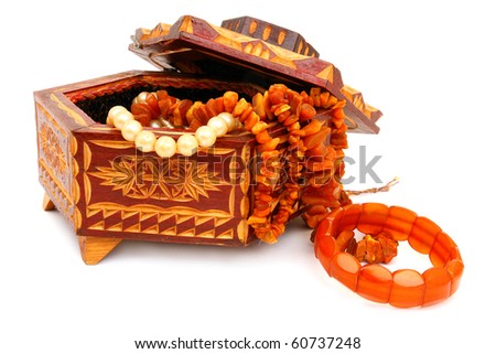 The wooden casket and amber isolated on white background