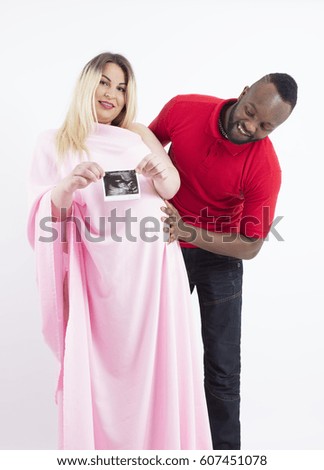 Photo of a pregnant international couple, isolated