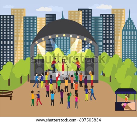 Musical festival in the neighborhood park. People dance and have fun outdoor next to scene with singers (band). There are Skyscrapers (blocks) behind event in the park