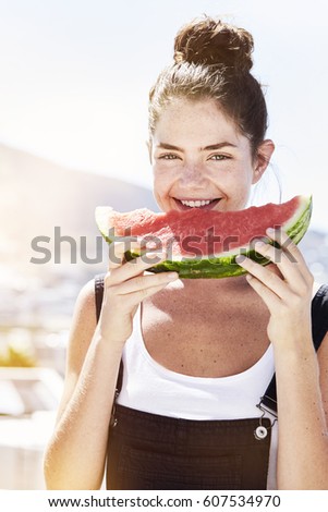 Brunette girl eating refreshing melon, portrait