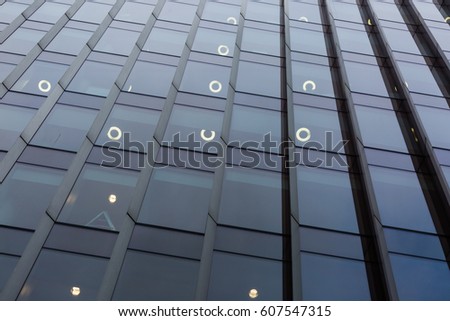 Abstract photo of the texture and reflection in the windows of a tall skyscraper in London, England