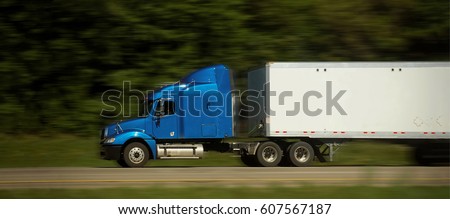 Highway with semi truck in route to deliver Royalty-Free Stock Photo #607567187