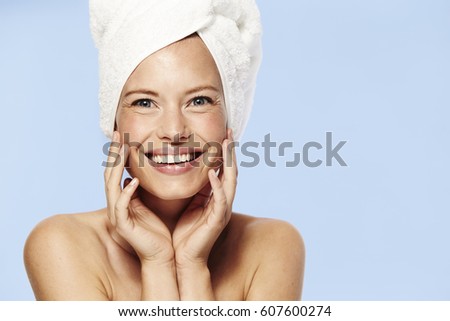 Stunning smile on beautiful woman wearing towel