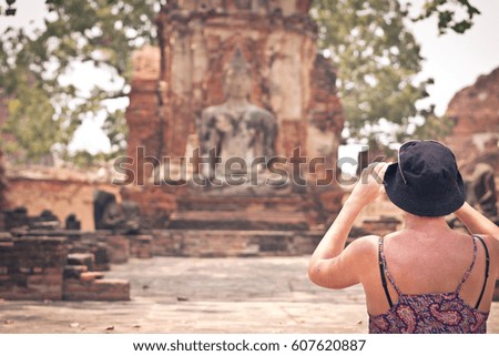 People take photo buddha ayutthaya thailand.