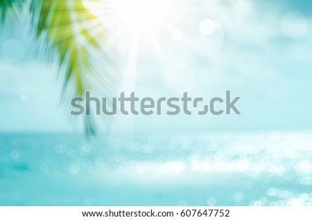 Blur beautiful nature green palm leaf on tropical beach with bokeh sun light wave abstract background. Copy space of summer vacation and business travel concept. Vintage tone filter effect color style Royalty-Free Stock Photo #607647752